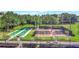Community bocce ball and tennis courts with shade structures and seating amidst mature trees at 4716 Heritage Trl, Leesburg, FL 34748