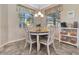 Cozy breakfast nook featuring a round table, four chairs, and natural light from the adjacent windows at 4716 Heritage Trl, Leesburg, FL 34748