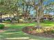 A well-manicured landscape and several parked golf carts sit near the clubhouse at 4716 Heritage Trl, Leesburg, FL 34748