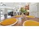 Close-up of dining area showing a place setting with the view from the kitchen to the breakfast area at 4716 Heritage Trl, Leesburg, FL 34748