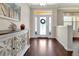 The foyer features beautiful wood-look flooring, bright white walls, and a decorative console table at 4716 Heritage Trl, Leesburg, FL 34748