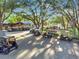 Many golf carts are parked in the shade of mature trees near the community clubhouse at 4716 Heritage Trl, Leesburg, FL 34748
