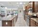 Well-equipped kitchen featuring modern stainless steel appliances and a large island with beautiful stone countertops at 4716 Heritage Trl, Leesburg, FL 34748