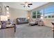 Comfortable living room featuring neutral colors, cozy seating, and large windows to let in natural light at 4716 Heritage Trl, Leesburg, FL 34748