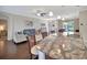 Bright open-concept living area with view from kitchen featuring comfortable seating and plenty of natural light at 4716 Heritage Trl, Leesburg, FL 34748