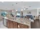 Spacious open-concept living area with view from kitchen featuring comfortable seating and plenty of natural light at 4716 Heritage Trl, Leesburg, FL 34748