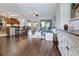 An open-concept layout connects the kitchen, living, and dining areas with beautiful wood-look flooring at 4716 Heritage Trl, Leesburg, FL 34748