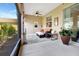Relaxing screened patio with comfortable seating and a ceiling fan at 4716 Heritage Trl, Leesburg, FL 34748