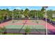 Well-maintained tennis courts offer a recreational space for active residents in a lush, green setting at 4716 Heritage Trl, Leesburg, FL 34748