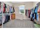 Spacious walk-in closet with ample hanging space, shelving, and a window for natural light at 4716 Heritage Trl, Leesburg, FL 34748