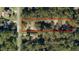 Aerial view shows property lines and surrounding lush greenery, showcasing the serene and private setting of the home at 5581 Sw 197Th Ter, Dunnellon, FL 34431