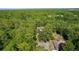 Property aerial view showcases a home surrounded by dense trees in Ocala, Florida at 5581 Sw 197Th Ter, Dunnellon, FL 34431