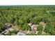 A high angle aerial shows the residence and property surrounded by lush, mature trees, highlighting the neighborhood's verdant landscape at 5581 Sw 197Th Ter, Dunnellon, FL 34431