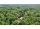 Lush foliage blankets the landscape, accentuating the quiet neighborhood and offering privacy to the homes below from an aerial perspective at 5581 Sw 197Th Ter, Dunnellon, FL 34431