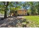 Backyard of two-story brick home, featuring a porch, stairs, and lots of shade at 5581 Sw 197Th Ter, Dunnellon, FL 34431