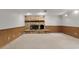Unfinished basement features a stone fireplace and wood-paneled wainscotting at 5581 Sw 197Th Ter, Dunnellon, FL 34431