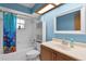 Cozy bathroom with blue walls, shower-tub combo, and vanity at 5581 Sw 197Th Ter, Dunnellon, FL 34431