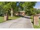 Property featuring a long private driveway flanked by brick pillars, leading to a charming brick home at 5581 Sw 197Th Ter, Dunnellon, FL 34431