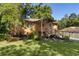 Inviting brick home with a quaint front porch, landscaped yard, and a detached structure offers charm and potential at 5581 Sw 197Th Ter, Dunnellon, FL 34431