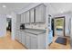 Spacious kitchen featuring gray cabinets, long countertop, and hardwood floors at 5581 Sw 197Th Ter, Dunnellon, FL 34431