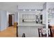 Kitchen featuring gray cabinets, modern appliances, and a view into the dining area at 5581 Sw 197Th Ter, Dunnellon, FL 34431