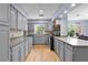 Bright kitchen with recessed lighting, gray cabinets, and modern appliances at 5581 Sw 197Th Ter, Dunnellon, FL 34431