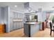 Well-lit kitchen featuring gray cabinets, hardwood floors, and modern appliances at 5581 Sw 197Th Ter, Dunnellon, FL 34431