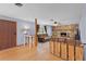 Comfortable living room with hardwood floors, stone fireplace, and brown leather sofa at 5581 Sw 197Th Ter, Dunnellon, FL 34431
