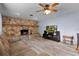 Cozy living room with a striking stone fireplace, neutral paint, modern flooring and ample natural light at 5581 Sw 197Th Ter, Dunnellon, FL 34431