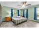 Bright and airy main bedroom features windows, ceiling fan, and wood-look floors at 5581 Sw 197Th Ter, Dunnellon, FL 34431