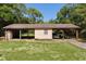 Covered outbuilding with parking and storage on a verdant lawn, offering ample space for vehicles and equipment at 5581 Sw 197Th Ter, Dunnellon, FL 34431