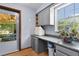 Bright storage area with gray cabinets, countertop space, and a view of the backyard at 5581 Sw 197Th Ter, Dunnellon, FL 34431