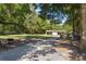 Property features a long driveway leading to a covered garage and wooded backyard at 5581 Sw 197Th Ter, Dunnellon, FL 34431