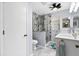 Modern bathroom with double sinks, quartz counters, and glass-enclosed walk-in shower with gray stone at 612 Lisbon Ln, The Villages, FL 32159