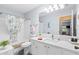 Bright bathroom with a large mirror and shower with decorative curtain at 612 Lisbon Ln, The Villages, FL 32159