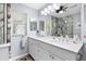 Modern bathroom with double sinks, quartz counters, and glass-enclosed walk-in shower with gray stone at 612 Lisbon Ln, The Villages, FL 32159