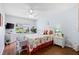 Charming bedroom features a ceiling fan, view of outdoors, and beachy decor at 612 Lisbon Ln, The Villages, FL 32159
