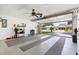 Spacious two car garage with epoxy flooring and a ceiling fan at 612 Lisbon Ln, The Villages, FL 32159