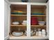 Kitchen cabinet showcasing organized dishware and dining essentials at 612 Lisbon Ln, The Villages, FL 32159
