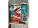 Open kitchen drawer stocked with measuring cups, utensils, and various cooking tools at 612 Lisbon Ln, The Villages, FL 32159