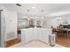 Open kitchen with white cabinets, stainless steel appliances, and an island with quartz counters at 612 Lisbon Ln, The Villages, FL 32159