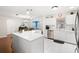 Bright kitchen features white cabinets, stainless steel appliances, quartz counters and opens to the living area at 612 Lisbon Ln, The Villages, FL 32159