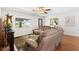 Relaxing living room featuring hardwood floors, a cozy seating arrangement, and a large window at 612 Lisbon Ln, The Villages, FL 32159