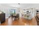 Open-concept living area featuring a dining area, breakfast bar, and an adjacent living room at 612 Lisbon Ln, The Villages, FL 32159