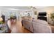 Open-concept living space with hardwood floors, connecting the kitchen, dining, and living areas for easy entertaining at 612 Lisbon Ln, The Villages, FL 32159