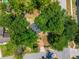Single-Gathering home featuring mature trees, brick walkway, and a roof with skylights, providing ample natural light at 640 Sailfish Rd, Winter Springs, FL 32708