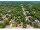 Beautiful aerial view of a property with a large lot surrounded by mature trees in a quiet neighborhood at 640 Sailfish Rd, Winter Springs, FL 32708
