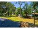 Large backyard space features mature trees and a shed at 640 Sailfish Rd, Winter Springs, FL 32708