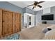 Bedroom featuring a TV, a dresser, and a barn door closet at 640 Sailfish Rd, Winter Springs, FL 32708