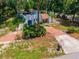 Unique single-Gathering home featuring a brick walkway, hillside landscape and fenced yard providing privacy and charm at 640 Sailfish Rd, Winter Springs, FL 32708